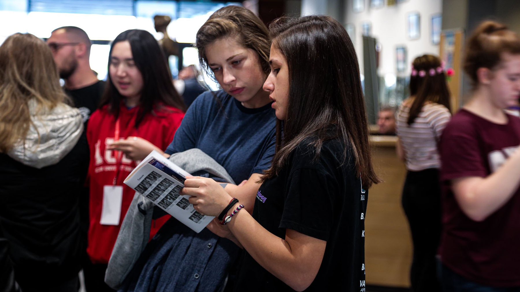 Two students looking at a magazine