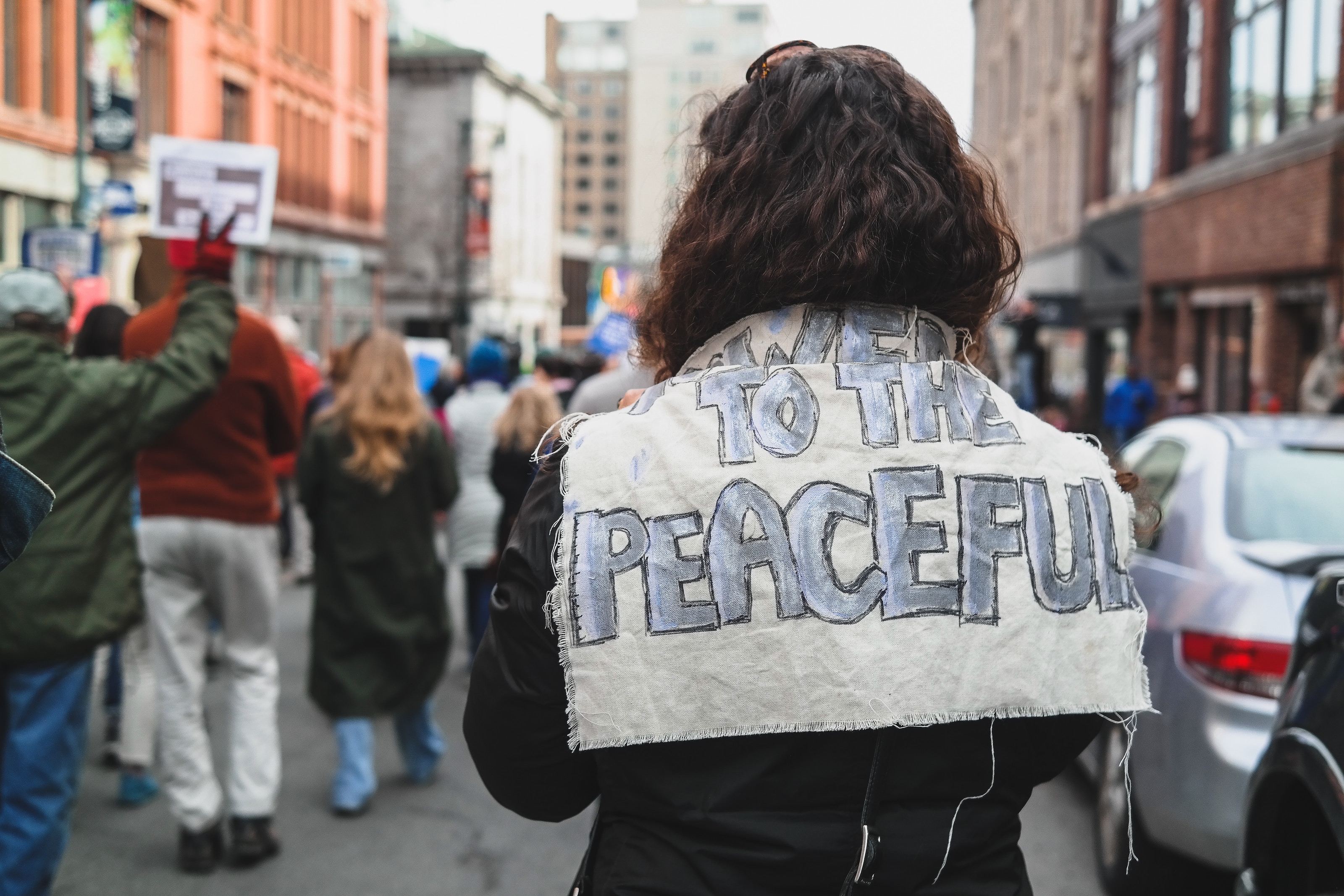 Woman with a sign on the back that says 