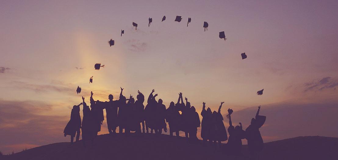 Student throwing graduation caps in the air